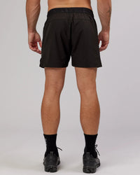Man wearing Competition 5" Performance Short - Black