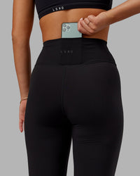 Woman wearing Fusion Ultra High-Rise Flared Legging - Black | Model:Milly | Size:S