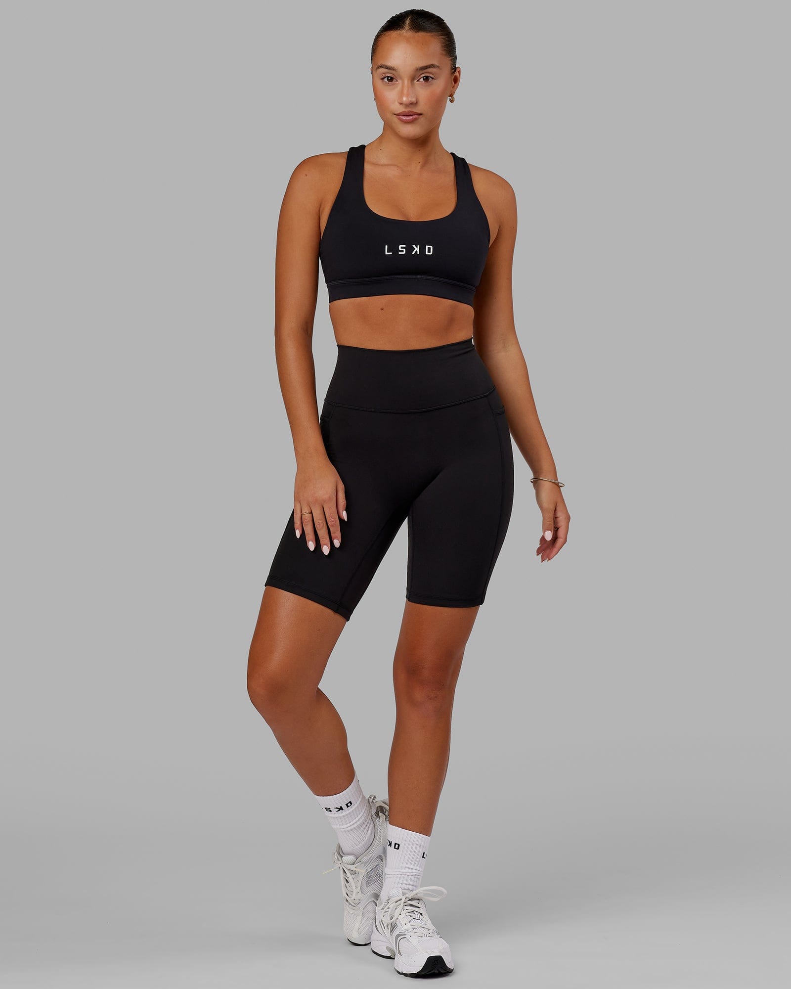 Woman wearing O.G. Fusion Ultra High-Rise 9" Short Pockets - Black | Model:Milly | Size:S
