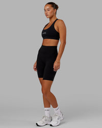 Woman wearing O.G. Fusion Ultra High-Rise 9" Short Pockets - Black | Model:Milly | Size:S