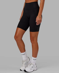 Woman wearing O.G. Fusion Ultra High-Rise 9" Short Pockets - Black | Model:Milly | Size:S