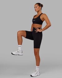 Woman wearing O.G. Fusion Ultra High-Rise 9" Short Pockets - Black | Model:Milly | Size:S