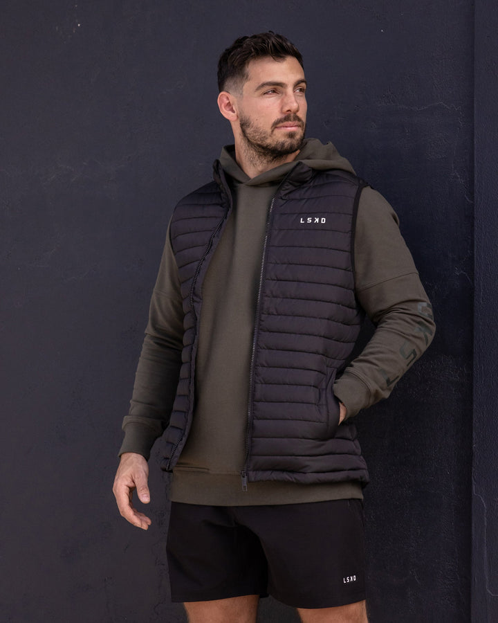 Man wearing Uplift Puffer Vest - Black Fade